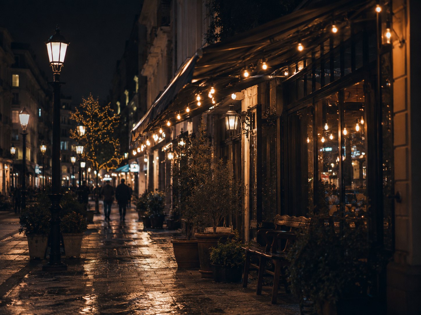 A couple walking through a softly lit city lane at night