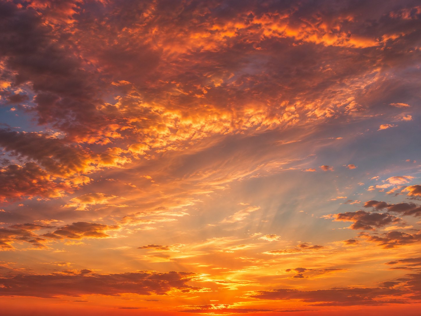 Orange and red clouds illuminated by a dramatic sunset